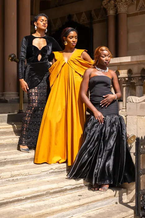 Fashion portraits in yellow and black gowns on stone steps, photographed by Imisi Bamiro, Coventry photographer