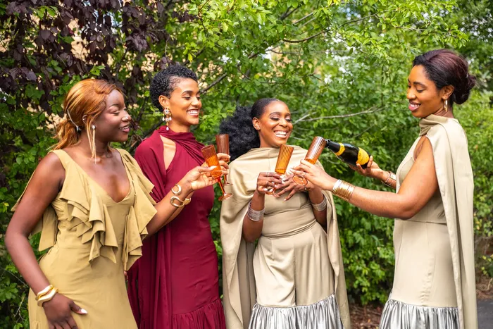 Group fashion shoot in satin gowns in a park, photographed by Imisi Bamiro, Coventry photographer
