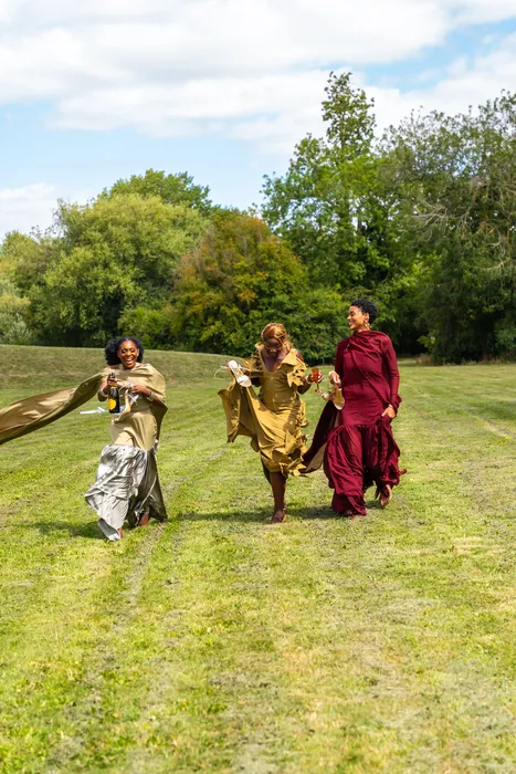 Group fashion shoot in satin gowns in a park, photographed by Imisi Bamiro, Coventry photographer