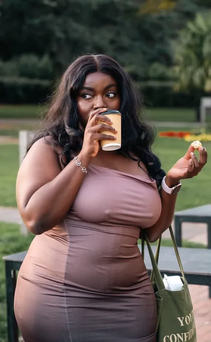 Lifestyle portrait of a woman in a nude dress outdoors, photographed by Imisi Bamiro, Coventry photographer
