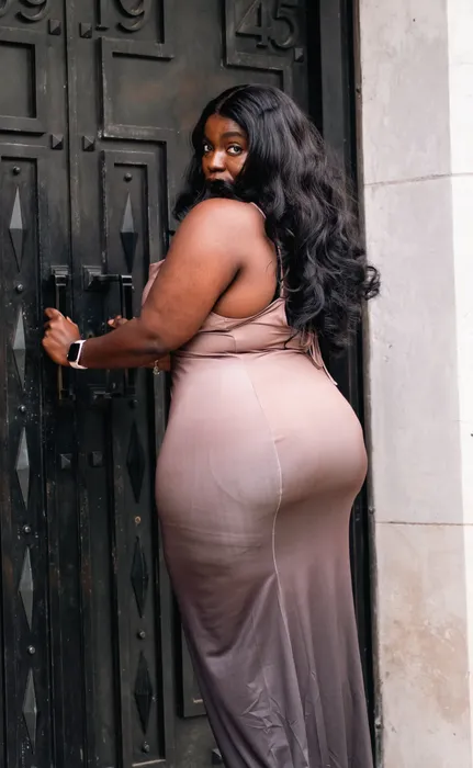 Lifestyle portrait of a woman in a nude dress outdoors, photographed by Imisi Bamiro, Coventry photographer