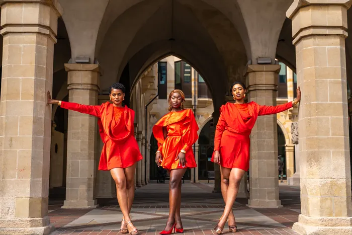 Three women in matching red dresses, fashion editorial, photographed by Imisi Bamiro, Coventry photographer